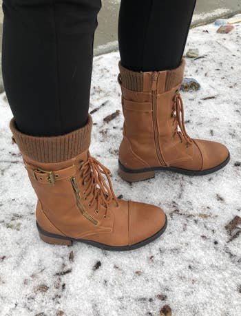 a reviewer wearing the boots in brown 