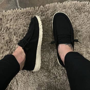 a reviewer wearing the shoes in black 