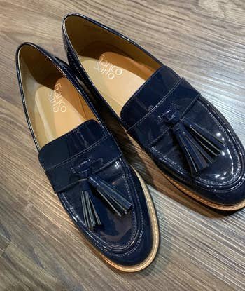 a reviewer photo of the patent loafers with tassel detailing in navy 