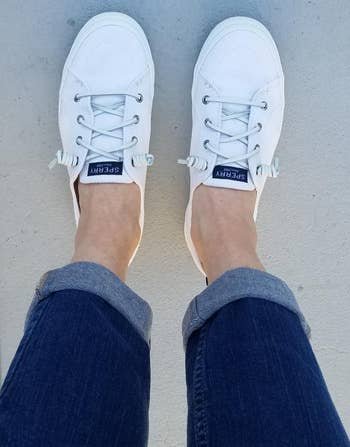 reviewer's feet in the white sneakers