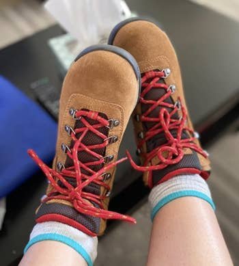 Tan hiking boots with red shoe laces